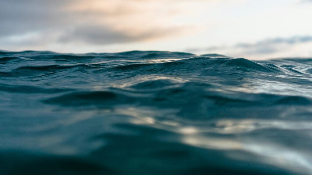 Close-up view of ocean waves with a dynamic sky, capturing the essence of nature's power.